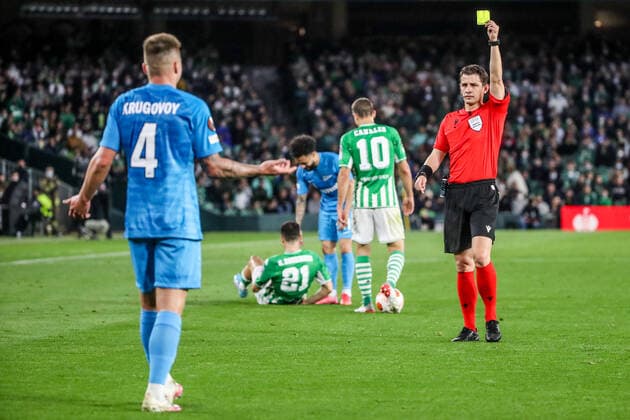SEVILLE, SPAIN â€“ FEBRUARY 24, 2022: Zenit St Petersburg s Daniil Krugovoi (L front) is shown a yellow card in the second leg of a UEFA Europa League playoff fooball match between Betis and Zenit St Petersburg at Benito Villamarin Stadium. Alexander Demianchuk TASS  TS1254D0