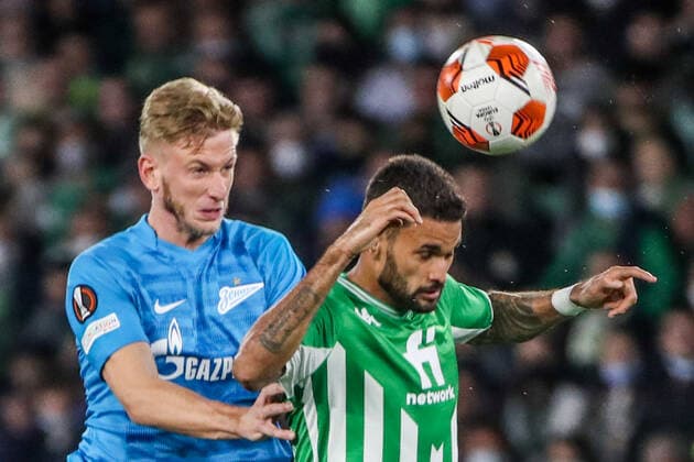 SEVILLE, SPAIN â€“ FEBRUARY 24, 2022: Zenit St Petersburg s Dmitry Chistyakov (L) and Betis s Willian Jose jump to head the ball in the second leg of a UEFA Europa League playoff fooball match between Betis and Zenit St Petersburg at Benito Villamarin Stadium. Alexander Demianchuk TASS  TS1254E0