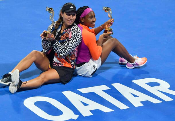 (220226) -- DOHA, Feb. 26, 2022 -- Cori Gauff (R) and Jessica Pegula of the United States pose with their trophies after the doubles final of the WTA, Tennis Damen Qatar Open tennis tournament against Veronica Kudermetova of Russia and Elise Mertens of Belgium in Doha, capital of Qatar, Feb. 25, 2022. (Photo by Xinhua) (SP)QATAR-DOHA-TENNIS-WTA QATAR OPEN-FINAL Nikku 