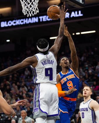March 7, 2022, Sacramento, CA, USA: New York Knicks guard RJ Barrett (9) drives to basket defended buy Sacramento Kings forward Justin Holiday (9) during a game at Golden 1 Center in Sacramento, Monday, March 7, 2022. Sacramento USA - ZUMAj89_ 0152635985st Copyright: xPaulxKitagakixJr.x