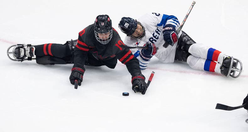 (220308) -- BEIJING, March 8, 2022 -- Ben Delaney (L) of Canada vies with Lee Jong Kyung of South Korea during the Preliminary Round Group A Match of Para Ice hockey, Eishockey between Canada and South Korea at Beijing 2022 Winter Paralympic Games in Beijing, capital of China, March 8, 2022. ) (SP)CHINA-BEIJING-WINTER PARALYMPICS-PARA ICE HOCKEY-GROUP A-CAN VS KOR(CN) CaixYang 