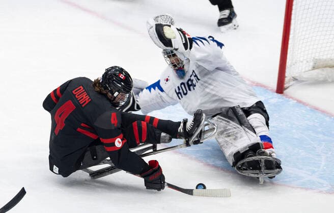 (220308) -- BEIJING, March 8, 2022 -- James Dunn (L) of Canada shoots during the Preliminary Round Group A Match of Para Ice hockey, Eishockey between Canada and South Korea at Beijing 2022 Winter Paralympic Games in Beijing, capital of China, March 8, 2022. ) (SP)CHINA-BEIJING-WINTER PARALYMPICS-PARA ICE HOCKEY-GROUP A-CAN VS KOR(CN) CaixYang 