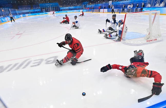 (220311) -- BEIJING, March 11, 2022 -- Garrett Riley (Front, R) of Canada competes during the para Ice hockey, Eishockey semifinal match between Canada and South Korea of Beijing 2022 Winter Paralympics at National Indoor Stadium in Beijing, March 11, 2022. ) (SP)CHINA-BEIJING-WINTER PARALYMPICS-PARA ICE HOCKEY-SEMIFINAL-CAN VS KOR WuxHuiwo 