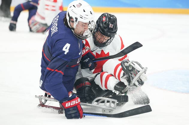 (220313) -- BEIJING, March 13, 2022 -- Brody Roybal (L) of the United States and Liam Hickey of Canada compete during the Para Ice hockey, Eishockey Gold Medal Game between the United States and Canada of the Beijing 2022 Paralympic Winter games, Winterspiele,Spiele, Summer games at National Indoor Stadium in Beijing, capital of China, March 13, 2022. ) (SP)CHINA-BEIJING-WINTER PARALYMPICS-PARA ICE HOCKEY-GOLD MEDAL GAME-USA VS CAN (CN) MaxXiping 