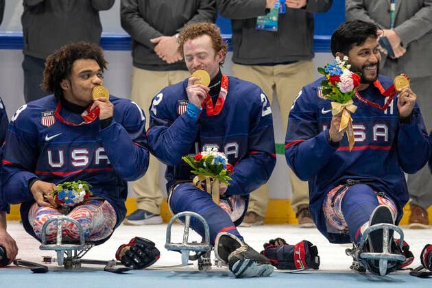 March 13, 2022, Beijing, Hebei, China: Team USA kisses their gold medals as they watch the American flag being hoisted after beating Canada for Gold in the finals of Ice hockey, Eishockey at the Beijing 2022 Paralympics. Beijing China - ZUMAh234 20220313_zsp_h234_001 Copyright: xMarkxEdwardxHarrisx