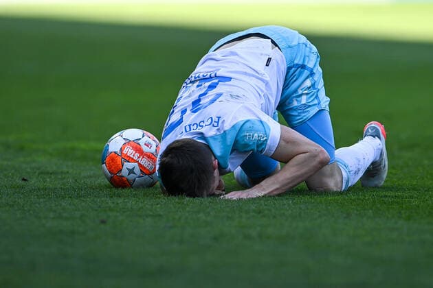 Reinhold Ranftl Schalke, 27 lying on the ground, racked with pain after a foul, cutout, full body, single image, action, action, 13 03 2022, Ingolstadt Germany , Football, 2 Bundesliga, FC Ingolstadt 04 FC Schalke 04, DFB DFL REGULATIONS PROHIBIT ANY USE OF PHOTOGRAPHS AS IMAGE SEQUENCES AND OR QUASI VIDEO xslx