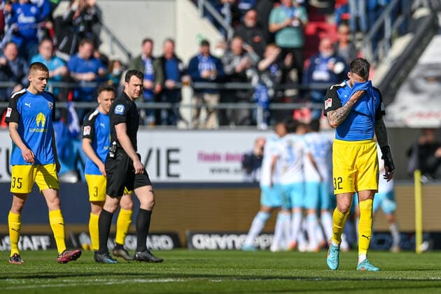 FC Ingolstadt players looking disappointed after conceding the 0 1 goal, disappointment, frustration, disappointed, pessimistic, in the background the Schalke players are cheering the goal, 13 03 2022, Ingolstadt Germany , Football, 2 Bundesliga, FC Ingolstadt 04 FC Schalke 04, DFB DFL REGULATIONS PROHIBIT ANY USE OF PHOTOGRAPHS AS IMAGE SEQUENCES AND OR QUASI VIDEO xslx