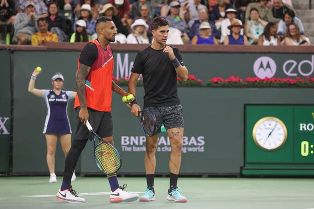 INDIAN WELLS, CA - MARCH 13: Nick Kyrgios (AUS) and doubles partner Thanasi Kokkinakis (AUS) discuss strategy during the BNP Paribas Open on March 13, 2022 at Indian Wells Tennis Garden in Indian Wells, CA. (Photo by George Walker Icon Sportswire) TENNIS: MAR 13 BNP Paribas Open Icon220313086
