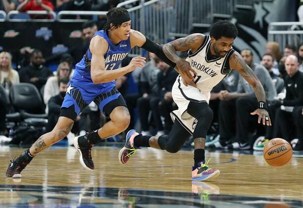 March 15, 2022, Orlando, Florida, USA: The Orlando Magic s R.J. Hampton (13) and the Brooklyn Nets Kyrie Irving (11) chase a loose ball at the Amway Center on Tuesday, March 15, 2022, in Orlando, Florida. Irving scored a career-high 60 points as the Nets won, 150-108. Orlando USA - ZUMAm67_ 0152759034st Copyright: xStephenxM.xDowellx