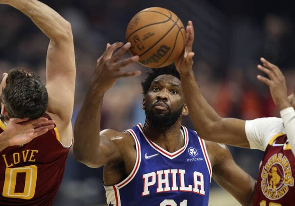 Philadelphia 76ers Joel Embiid (21) attempts to grab a rebound Cleveland Cavaliers Kevin Love (0) and Darius Garland (10) at Rocket Mortgage Field House in Cleveland, Ohio on Wednesday, March 16, 2022.  CLE202203161104 AARONxJOSEFCZYK