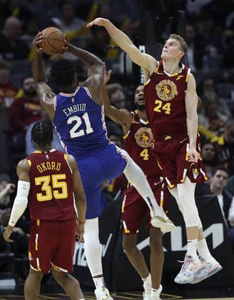 Cleveland Cavaliers Lauri Markkanen (24) attempts to block the shot Philadelphia 76ers Joel Embiid (21) at Rocket Mortgage Field House in Cleveland, Ohio on Wednesday, March 16, 2022.  CLE20220316113 AARONxJOSEFCZYK