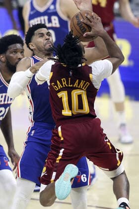 Cleveland Cavaliers Darius Garland(10) puts up a shot over Philadelphia 76ers Tobias Harris (12) at Rocket Mortgage Field House in Cleveland, Ohio on Wednesday, March 16, 2022.  CLE20220316108 AARONxJOSEFCZYK
