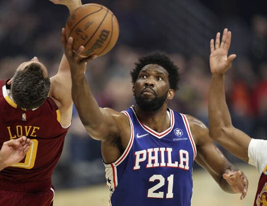 Philadelphia 76ers Joel Embiid (21) attempts to grab a rebound Cleveland Cavaliers Kevin Love (0) and Darius Garland (10) at Rocket Mortgage Field House in Cleveland, Ohio on Wednesday, March 16, 2022.  CLE202203161125 AARONxJOSEFCZYK