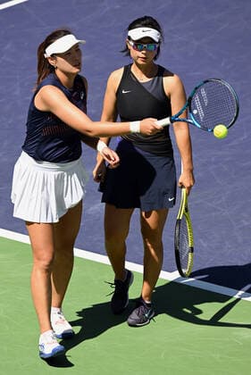 INDIAN WELLS, CA - MARCH 19: Zhaoxuan Yang of China gets a ball while talking with her double partner Yifan Xu of China during a final tennis match at the BNP Paribas Open played on March 19, 2022 at the Indian Wells Tennis Garden in Indian Wells, CA. (Photo by John Cordes Icon Sportswire) TENNIS: MAR 19 BNP Paribas Open Icon506220319002