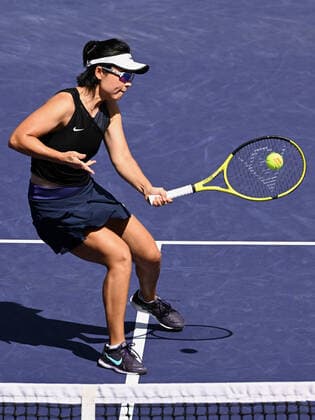 INDIAN WELLS, CA - MARCH 19: Yifan Xu of China returns a shot near the net during a doubles finals tennis match at the BNP Paribas Open played on March 19, 2022 at the Indian Wells Tennis Garden in Indian Wells, CA. (Photo by John Cordes Icon Sportswire) TENNIS: MAR 19 BNP Paribas Open Icon506220319025