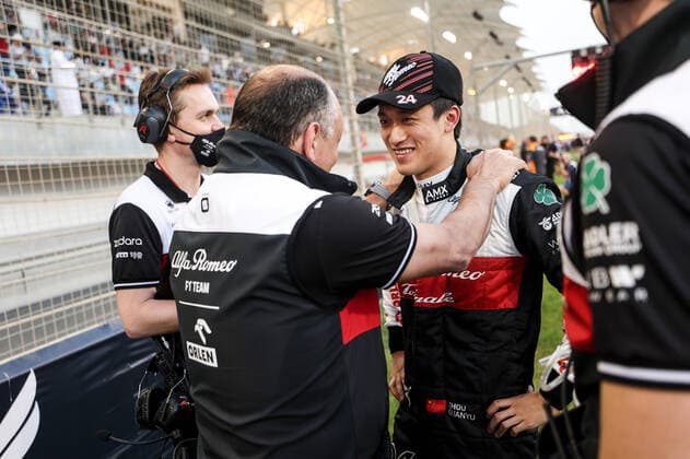 (220321) -- SAKHIR, March 21, 2022 -- Alfa Romeo s Chinese driver Zhou Guanyu (R) chats with his team during the Bahrain Formula One Grand Prix at the Bahrain International Circuit in the city of Sakhir on March 20, 2022. (DPPI Handout via Xinhua) (SP)BAHRAIN-SAKHIR-F1-BAHRAIN GRAND PRIX 2022-FINAL WangxHaizhou 