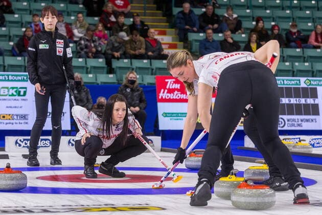 March 22, 2022, Prince George, BC, Canada: Team Japan skip Ikue Kitazawa, left to right, looks on as Team Canada skip Kerri Einarson watches lead Briane Meilleur, and second Shannon Birchard sweep in front of a rock as it enters the house at CN Centre on Tuesday afternoon during at the Women s World Curling in Prince George, B.C., on Tuesday, March 22, 2022. Canada News - March 22, 2022 - ZUMAc35_ 20220322_zaf_c35_138 Copyright: xJamesxDoylex