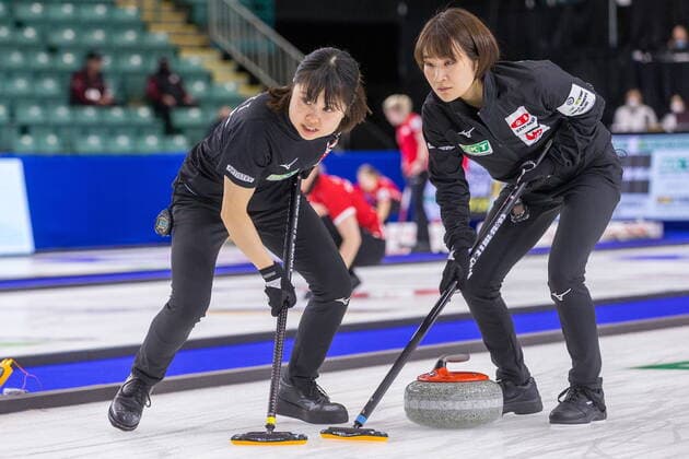 March 22, 2022, Prince George, BC, Canada: Team Japan second Minori Suzuki, left, and third Seina Nakajima sweep in front of a stone at CN Centre on Tuesday afternoon during at the Women s World Curling in Prince George, B.C., on Tuesday, March 22, 2022. Canada News - March 22, 2022 - ZUMAc35_ 20220322_zaf_c35_140 Copyright: xJamesxDoylex