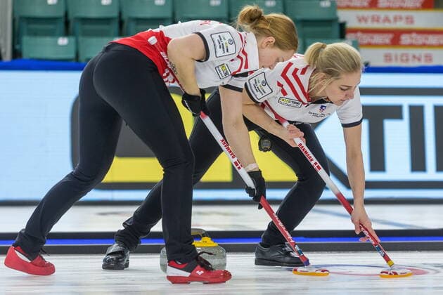 March 23, 2022, Prince George, BC, Canada: Denmark third Mathilde Halse, left, and second Denise Dupont sweep in front of a stone against South Korea at the Women s World Curling Championship in Prince George, B.C., on Wednesday, March 23, 2022. Canada News - March 23, 2022 - ZUMAc35_ 20220323_zaf_c35_095 Copyright: xJamesxDoylex