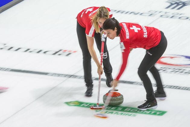 March 23, 2022, Prince George, BC, Canada: Switzerland lead Melanie Barbezat, left, and second Esther Neuenschwander sweep in front of a stone in a match aagainst Czech Republic at the Women s World Curling Championship in Prince George, B.C., on Wednesday, March 23, 2022. Canada News - March 23, 2022 - ZUMAc35_ 20220323_zaf_c35_101 Copyright: xJamesxDoylex