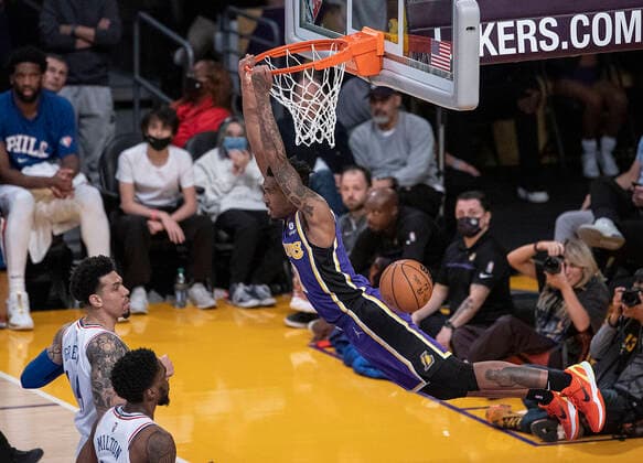 March 23, 2022, Los Angeles, California, USA: Malik Monk 11 of the Los Angeles Lakers hangs unto the rim after dunking the ball during their NBA, Basketball Herren, USA game against the Philadelphia 76ers on Wednesday March 23, 2022 at Crypto.com Arena in Los Angeles, California. Lakers lose to 76ers, 121-126. PI Los Angeles USA - ZUMAp124 20220323_zaa_p124_034 Copyright: xJAVIERxROJASx