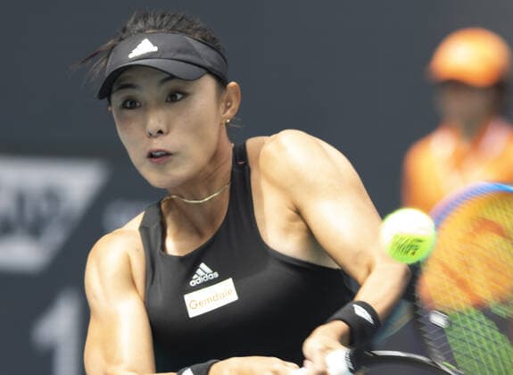 Qiang Wang from China hits a two handed backhand to Cori Gauff from the USA at the Miami Open in the Hard Rock Stadium in Miami Gardens, Florida, on Friday, March 25, 2022. Gauff defeated Wang 7-5, 6-4.  MIA20220325105 GARYxIxROTHSTEIN