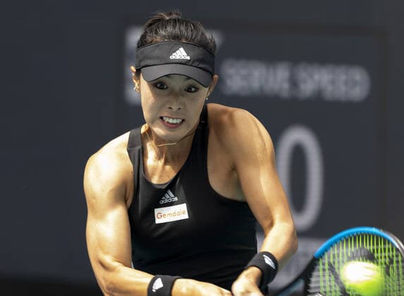 Qiang Wang from China hits a two handed backhand to Cori Gauff from the USA at the Miami Open in the Hard Rock Stadium in Miami Gardens, Florida, on Friday, March 25, 2022. Gauff defeated Wang 7-5, 6-4.  MIA20220325106 GARYxIxROTHSTEIN
