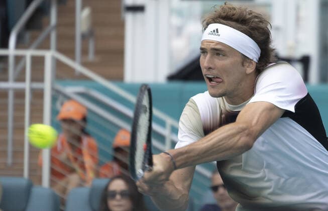 Alexander Zverev from Germany returns the ball back to Borna Coric from Croatia at the Miami Open in the Hard Rock Stadium in Miami Gardens, Florida, on Friday, March 25, 2022. Zverev defeated Coric 6-4, 3-6, 6-4 in three sets.  MIA20220325111 GARYxIxROTHSTEIN