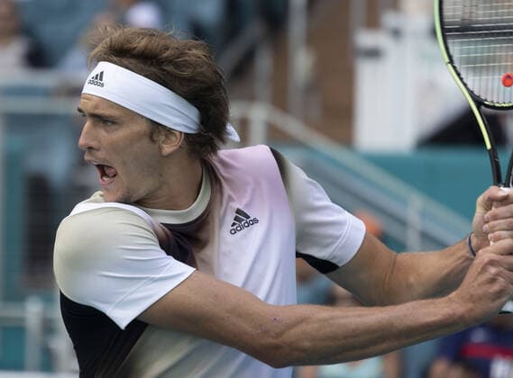 Alexander Zverev from Germany returns the ball back to Borna Coric from Croatia at the Miami Open in the Hard Rock Stadium in Miami Gardens, Florida, on Friday, March 25, 2022. Zverev defeated Coric 6-4, 3-6, 6-4 in three sets.  MIA20220325112 GARYxIxROTHSTEIN