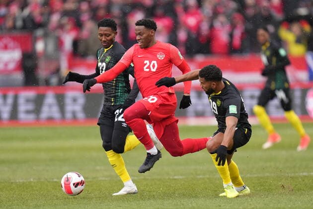 March 27, 2022, TORONTO, ON, CANADA: Canada s Jonathan David dribbles between Jamaica s Devon Williams (left) and Adrian Mariappa during first half CONCACAF World Cup soccer qualifying action in Toronto on Sunday, March 27, 2022. Canada News - March 27, 2022  - ZUMAc35_ 20220327_zaf_c35_068 Copyright: xNathanxDenettex