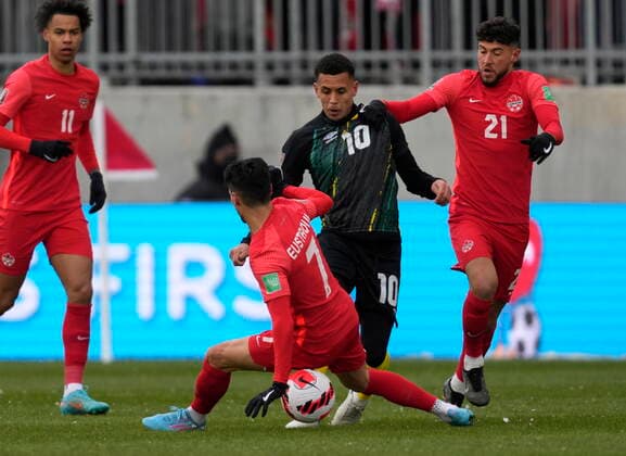 March 27, 2022, TORONTO, ON, CANADA: Canada s Tajon Buchanan (left to right), Stephen Eustaquio and Jonathan Osorio defend against Jamaica s Ravel Morrison during first half CONCACAF World Cup soccer qualifying action in Toronto on Sunday, March 27, 2022. Canada News - March 27, 2022  - ZUMAc35_ 20220327_zaf_c35_075 Copyright: xFrankxGunnx