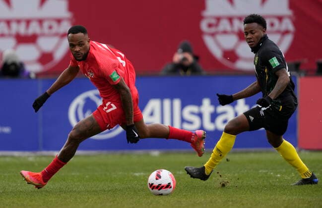 March 27, 2022, TORONTO, ON, CANADA: Canada s Cyle Larin and Jamaica s Javain Brown eye the ball during first half CONCACAF World Cup soccer qualifying action in Toronto on Sunday, March 27, 2022. Canada News - March 27, 2022  - ZUMAc35_ 20220327_zaf_c35_076 Copyright: xFrankxGunnx