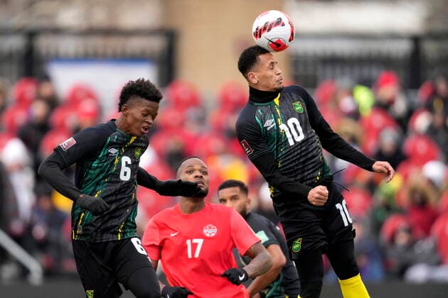 March 27, 2022, TORONTO, ON, CANADA: Jamaica s Ravel Morrison heads the ball as teammate Richard King and Canada s Cyle Larin look on during first half CONCACAF World Cup soccer qualifying action in Toronto on Sunday, March 27, 2022. Canada News - March 27, 2022  - ZUMAc35_ 20220327_zaf_c35_077 Copyright: xFrankxGunnx