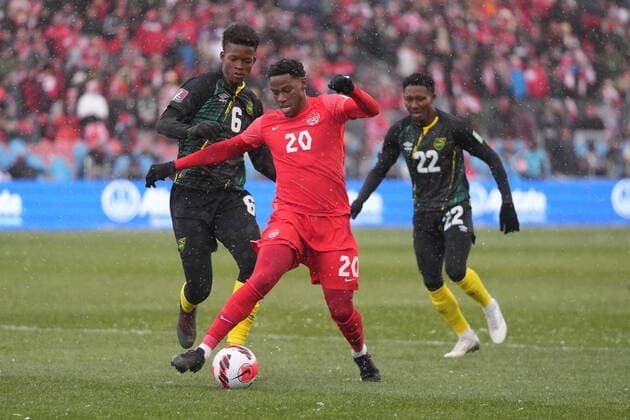 March 27, 2022, TORONTO, ON, CANADA: Canada s Jonathan David breaks away from Jamaica s Richard King (left) and Devon Williams during first half CONCACAF World Cup soccer qualifying action in Toronto on Sunday, March 27, 2022. Canada News - March 27, 2022  - ZUMAc35_ 20220327_zaf_c35_078 Copyright: xNathanxDenettex