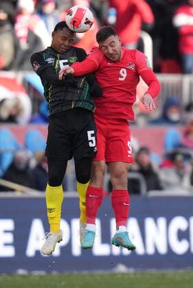 March 27, 2022, TORONTO, ON, CANADA: Canada s Lucas Cavallini and Jamaica s Tarrick Ximines go up for the ball during second half CONCACAF World Cup soccer qualifying action in Toronto on Sunday, March 27, 2022. Canada News - March 27, 2022  - ZUMAc35_ 20220327_zaf_c35_124 Copyright: xNathanxDenettex