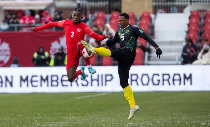 (220328) -- TORONTO, March 28, 2022 -- Samuel Adekugbe (L) of Canada vies with Tarrick Ximines of Jamaica during the FIFA World Cup, WM, Weltmeisterschaft, Fussball CONCACAF qualifiers match between Canada and Jamaica in Toronto, Canada, on March 27, 2022. (Photo by Zou Zheng Xinhua) (SP)CANADA-TORONTO-SOCCER-FIFA WORLD CUP QUALIFICATION-CANADA VS JAMAICA LinxWei 