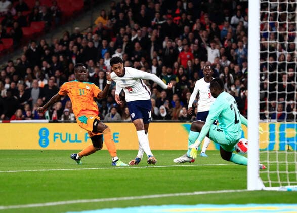 29th March 2022 ; Wembley Stadium, London, England; International football friendly, England versus Ivory Coast; Jude Bellingham of England taking a shot but keeper Sangare gets a leg to the shot and rebounds from the goal post  ActionPlus12374081 JohnxPatrickxFletcher