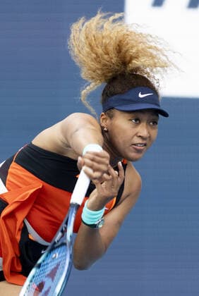 Naomi Osaka from Japan serves to Belinda Bencic from Switzerland during the semi-finals at the Miami Open in the Hard Rock Stadium in Miami Gardens, Florida, on Thursday, March 31, 2022.  MIA20220331122 GARYxIxROTHSTEIN