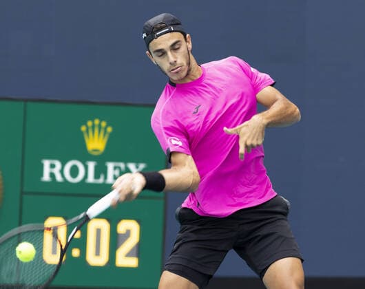Francisco Cerundolo from Argentina returns a forehand shot to Casper Ruud from Norway during the semi-finals at the Miami Open in the Hard Rock Stadium in Miami Gardens, Florida, on Friday, April 1, 2022. Ruud defeated Cerundolo 6-4, 6-1 to advance to the finals.  MIA20220401105 GARYxIxROTHSTEIN