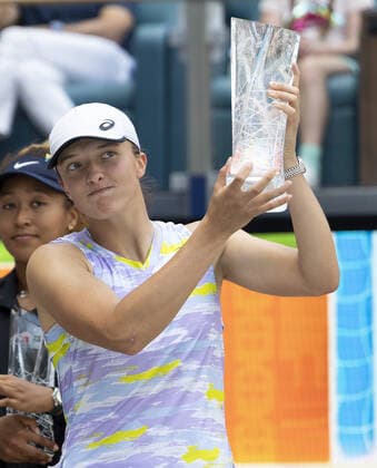 Iga Swiatek from Poland holds the winning trophy after defeating Naomi Osaka from Japan during the women?s finals at the Miami Open in the Hard Rock Stadium in Miami Gardens, Florida, on Saturday, April 2, 2022. Swiatek defeated Osaka 6-4, 6-0 winning the women?s championship.  MIA20220402113 GARYxIxROTHSTEIN
