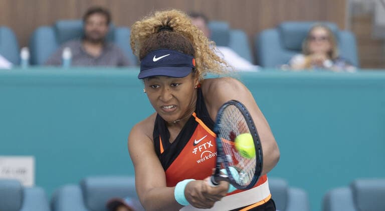 Naomi Osaka from Japan returns a two handed backhand shot to Iga Swiatek from Poland during the women s finals at the Miami Open in the Hard Rock Stadium in Miami Gardens, Florida, on Saturday, April 2, 2022. Swiatek defeated Osaka 6-4, 6-0 to win the women s championship.  MIA20220402118 GARYxIxROTHSTEIN