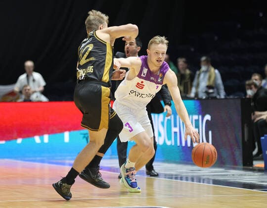 Harald Frey BG Goettingen in duel with Arturs Zagars Basketball Loewen Braunschweig
