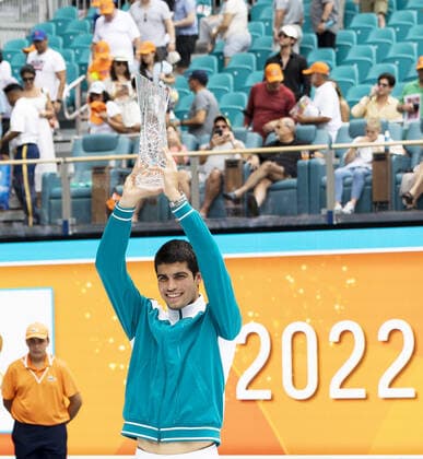 Carlos Alcaraz from Spain holds up the winning trophy after defeating Casper Ruud from Norway during the man?s finals at the Miami Open in the Hard Rock Stadium in Miami Gardens, Florida, on Sunday, April 3, 2022. Alcaraz defeated Ruud 7-5, 6-4 to win the men?s championship.  MIA20220403107 GARYxIxROTHSTEIN