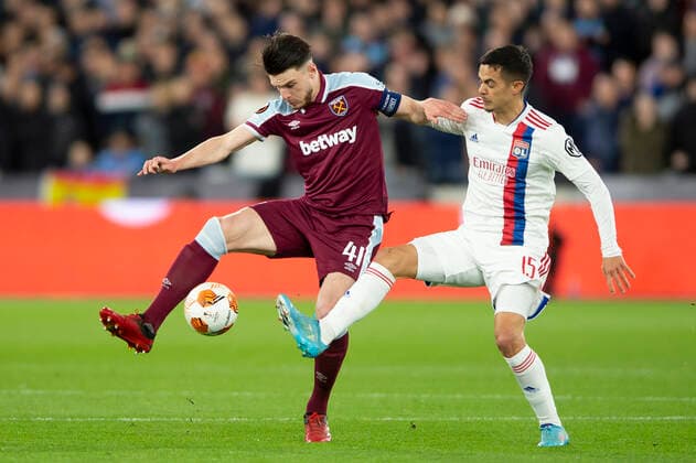 Declan Rice of West Ham United and Romain Faivre of Lyon during the UEFA Europa League quarter final match between West Ham United and Lyon at the London Stadium, Queen Elizabeth Olympic Park, London, England on 7 April 2022. Copyright: xSalvioxCalabresex 31600003
