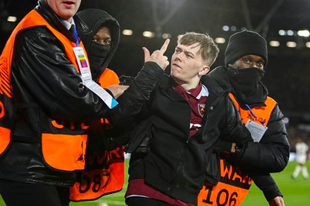 London, England, 7th April 2022. A pitch invader is removed from the field during the UEFA Europa League match at the London Stadium, London. Picture credit should read: Kieran Cleeves Sportimage EDITORIAL USE ONLY. No use with unauthorised audio, video, data, fixture lists, club league logos or live services. Online in-match use limited to 120 images, no video emulation. No use in betting, games or single club league player publications. SPI-1634-0061