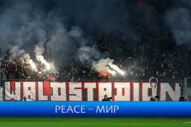 Soccer Europa League quarterfinals Eintracht Frankfurt FC Barcelona on 07 04 2022 at Deutsche Bank Park in Frankfurt Behind a forest stadium banner fence flag pyrotechnics are ignited UR
