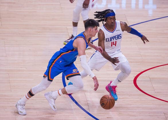 April 10, 2022, Los Angeles, California, USA: Georgios Kalaitzakis 18 of the Oklahoma Thunder attempts to run past Terance Mann 14 of the Los Angeles Clippers during their NBA, Basketball Herren, USA game on Sunday April 10, 2022 at Crypto.com Arena in Los Angeles, California. Clippers defeat Thunder, 138-88. ARIANA RUIZ PI Los Angeles USA - ZUMAp124 20220410_zaa_p124_037 Copyright: xArianaxRuizx