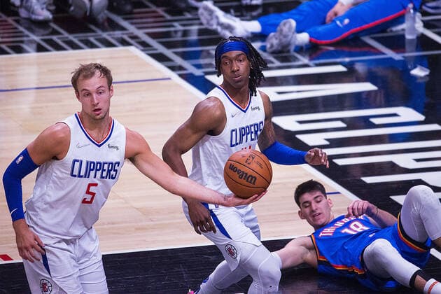 April 10, 2022, Los Angeles, California, USA: Luke Kennard 5 and Terance Mann 14 of the Los Angeles Clippers grab the rebound while Georgios Kalaitzakis 18 of the Oklahoma Thunder falls to the floor during their NBA, Basketball Herren, USA game on Sunday April 10, 2022 at Crypto.com Arena in Los Angeles, California. Clippers defeat Thunder, 138-88. ARIANA RUIZ PI Los Angeles USA - ZUMAp124 20220410_zaa_p124_052 Copyright: xArianaxRuizx