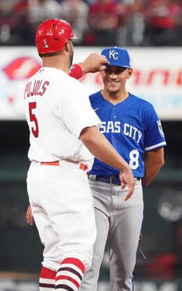 St. Louis Cardinals Albert Pujols plays with the cap of Kansas City Royals second baseman Nicky Lopez after hitting a single in the fifth inning at Busch Stadium in St. Louis on Tuesday, April 12, 2022.  SLP2022041218 BILLxGREENBLATT