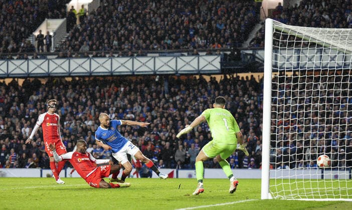 Mandatory Credit: Photo by Stuart Wallace Shutterstock (12893325bj) Kemar Roofe of Rangers scores to give Rangers a 3-1 lead (agg. 3-2), with Andre Horta of SC Braga, left, & SC Braga goalkeeper Matheus, right. Rangers v Braga, UEFA Europa League, Quarter Final, Second Leg, Football, Ibrox Stadium, Glasgow, UK - 14 Apr 2022 EDITORIAL USE ONLY No use with unauthorised audio, video, data, fixture lists, club league logos or live services. Online in-match use limited to 120 images, no video emulation. No use in betting, games or single club league player publications. Rangers v Braga, UEFA Europa League, Quarter Final, Second Leg, Football, Ibrox Stadium, Glasgow, UK - 14 Apr 2022 EDITORIAL USE ONLY No use with unauthorised audio, video, data, fixture lists, club league logos or live services. Online in-match use limited to 120 images, no video emulation. No use in betting, games or single club league player publications.  Copyright: xStuartxWallace Shutterstockx 12893325bj